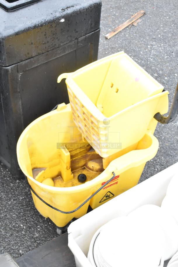 Lot of various items including yellow mop bucket with wringer, poly white bin, and stacked white ceramic plates. Used condition.