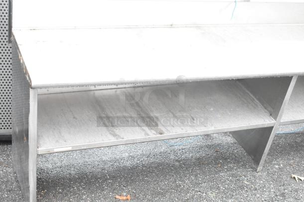 Stainless steel commercial table with two food strip warmers, under shelves, and over shelves, in used condition.