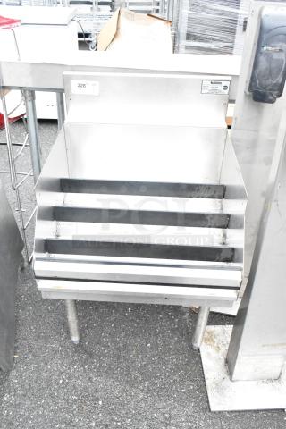 Krowne KR21-24RD stainless steel commercial bottle display rack with four levels, durable condition, NSF certified label visible.