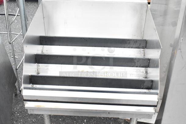 Krowne KR21-24RD stainless steel commercial bottle display rack, four-tier design, used condition, durable construction.