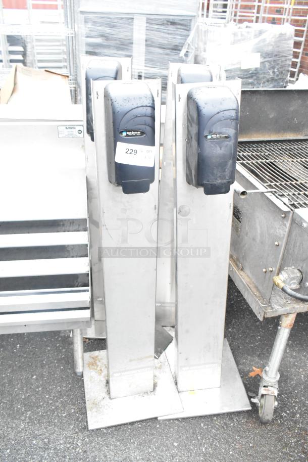 4 San Jamar poly soap dispensers on metal stands, gently used, label 229 visible, stainless steel bases.