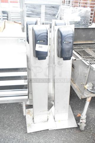 4 San Jamar poly soap dispensers on metal stands, gently used, label 229 visible, stainless steel bases.