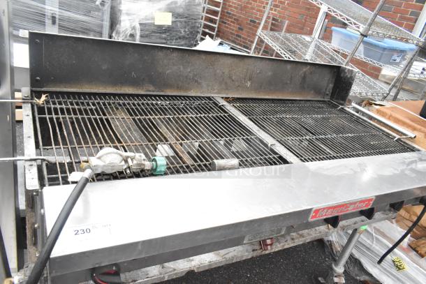 MagiCater stainless steel propane charbroiler grill with commercial casters, used condition, visible labels and gas connector.