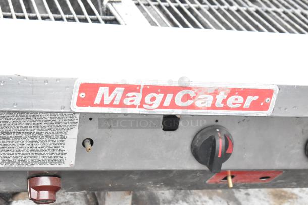 MagiCater stainless steel propane gas charbroiler grill with commercial casters, visible brand logo, and control knobs.