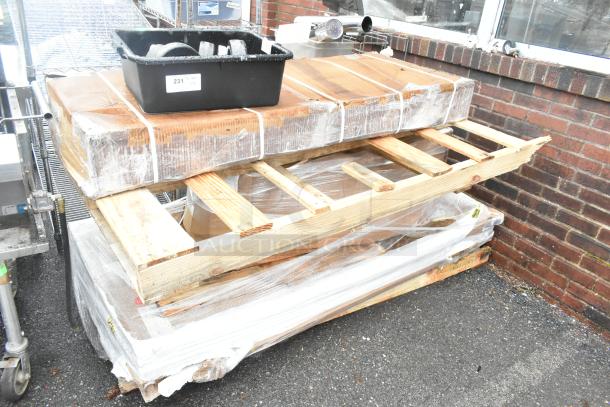 Unused pallet with various items including HLPLRW7230.LTM1 HON Mod 72"x30" Traditional Mahogany worksurfaces. Packaging visible.