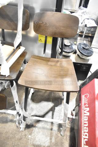 Black metal bar height chair with wooden seat and backrest, brand new with minor scratches and dents, protective wrapping visible.