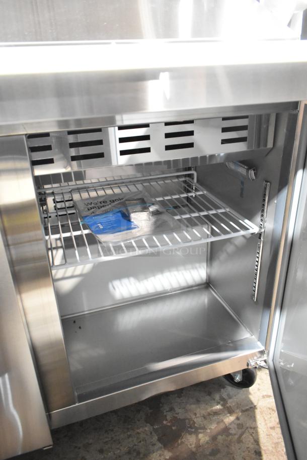 Avantco 178APT71MHC stainless steel prep table, brand new with minor scratches. Features interior shelving and commercial casters.