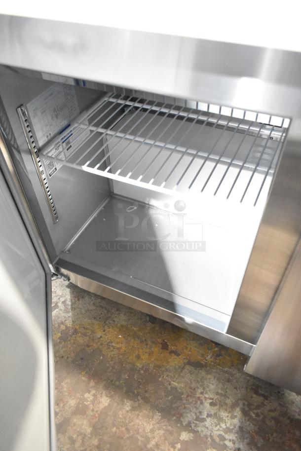 Brand new Avantco 178APT71MHC stainless steel prep table, interior view. Includes shelf. Scratch and dent condition.
