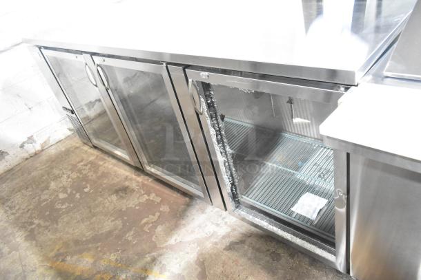 Avantco 178UBB4GHCS stainless steel back bar refrigerator, 90", glass doors, LED lighting, broken glass pane visible.
