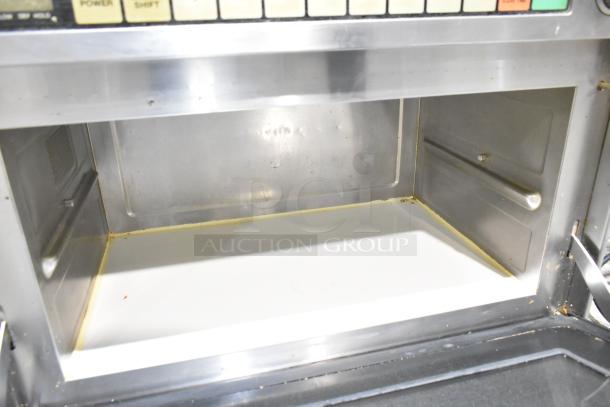 Panasonic NE-2180 stainless steel commercial microwave oven, 208 volts, countertop model, interior view showing light wear.
