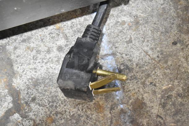 Alt text: Panasonic NE-2180 stainless steel commercial microwave plug, showing 208-volt connector.