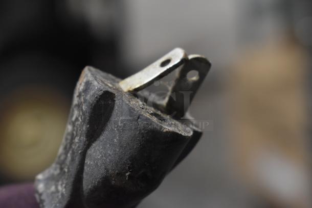 Close-up of a worn electrical plug from an Alto Shaam 1000-UP/P holding cabinet, showing two prongs with visible wear.