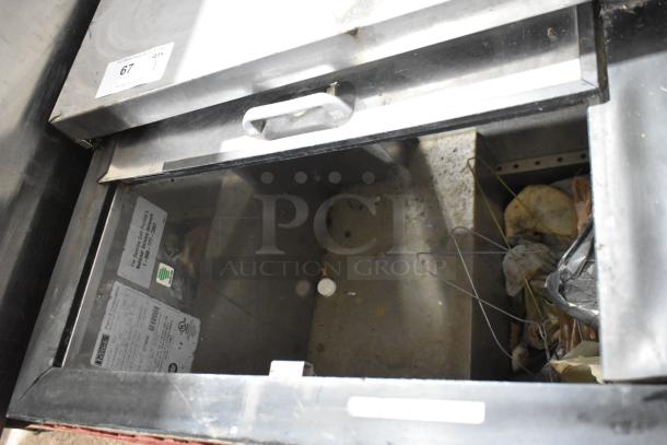 Perlick BC60 metal commercial back bar bottle cooler, 2 sliding lids, visible interior. Model details tag with 115 volts, 1 phase.