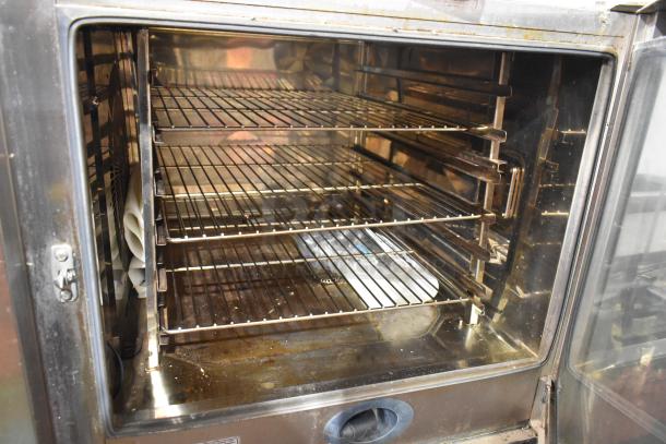 Rational CMP 62G CombiMaster Plus stainless steel gas combi convection oven, interior racks visible, mounted on equipment stand.