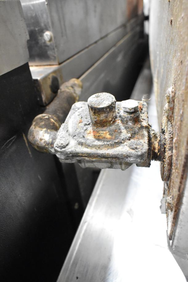 Rusted component of Vulcan stainless steel commercial gas charbroiler grill, highlighting wear and corrosion.