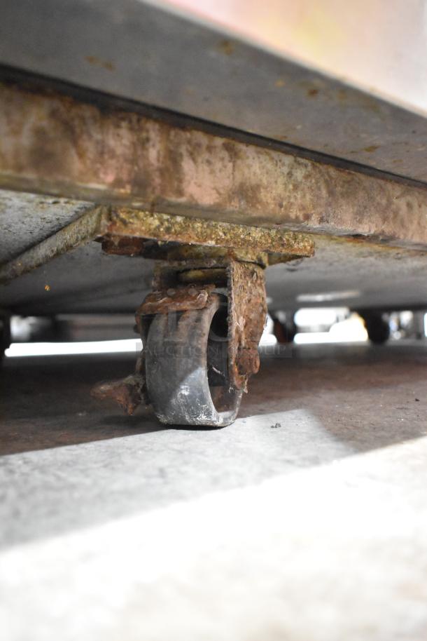 Continental stainless steel commercial chef base with six drawers on casters, visible rust and wear, 115V, 1 phase.