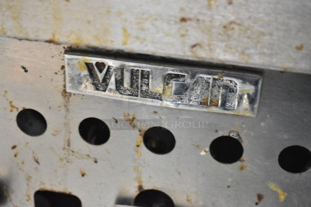 Vulcan stainless steel charbroiler grill label, showing branding. Grill is countertop, natural gas, with equipment stand.