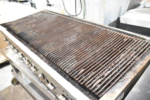 Vulcan stainless steel commercial charbroiler grill on stand with casters, natural gas powered, in used condition.