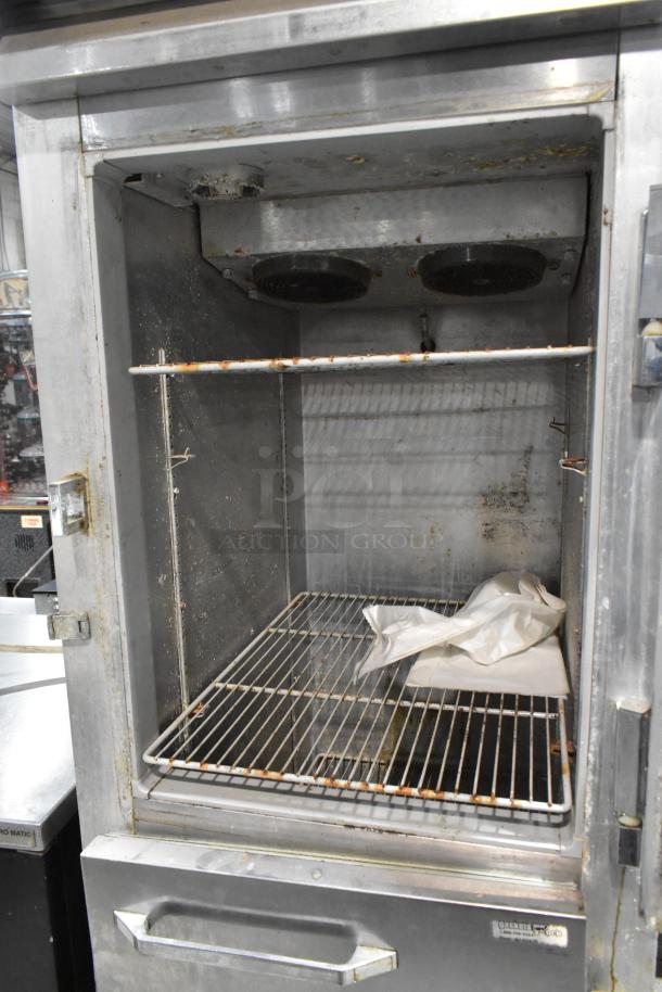 Continental 1R-HD stainless steel reach-in cooler with two half doors and commercial casters. Visible use and wear.