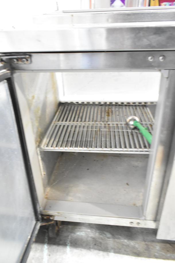 Continental CPA60 stainless steel commercial prep table, double-door interior view, on casters, used condition. 115V, 1 Phase.