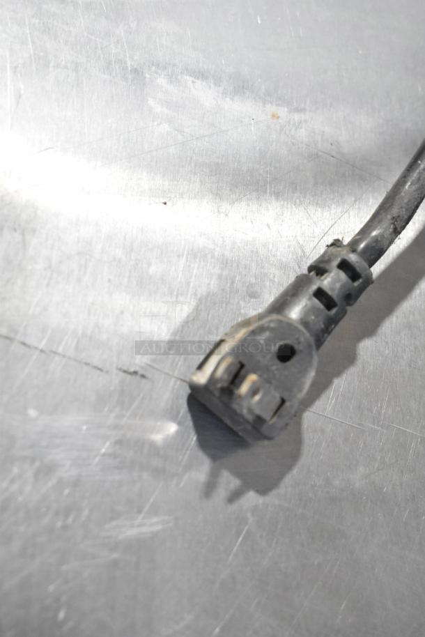 Power plug of Continental UR27 undercounter cooler, showing electrical connection details on a stainless steel surface.