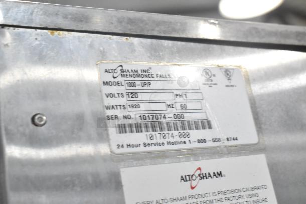 Alto Shaam 1000-UP/P label showing model, volt, watt, and serial number details on stainless steel surface.