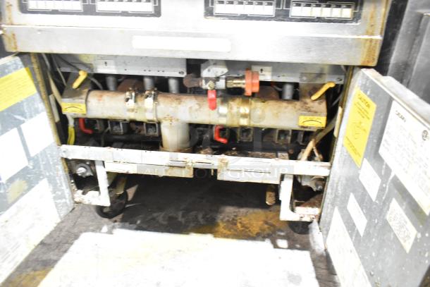 Dean SCFHD250GNC stainless steel natural gas commercial fryer, 2 bay, 100,000 BTU. Visible wear and maintenance labels.