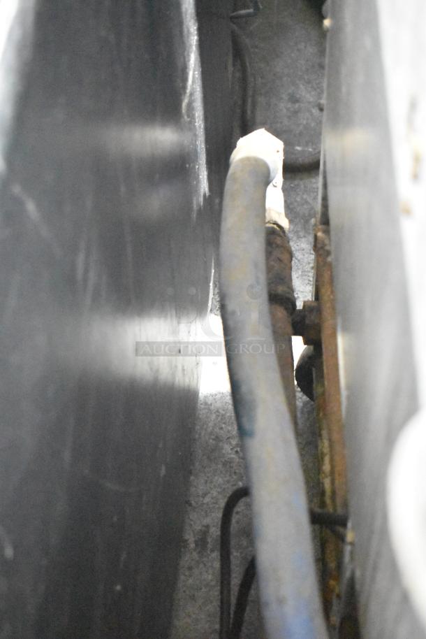 Dean SCFHD250GNC natural gas commercial fryer; detail view of back hoses and connections. Sturdy construction, slight wear.