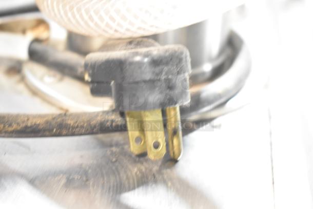 Close-up of power plug for True TDB-24-48 kegerator, showing a standard three-prong configuration with visible wear.