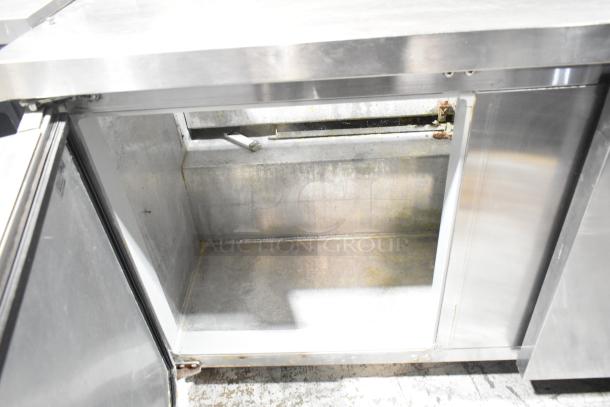Continental BW60-16 stainless steel sandwich prep table interior, showing wear, on commercial casters. 115V, 1 Phase.