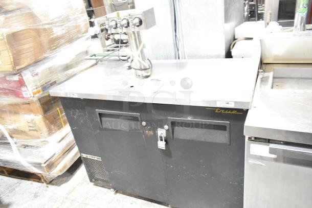 True TDB-24-48 metal commercial kegerator with 3-tap beer tower, black finish, 115V, 1 phase. Visible wear on doors.