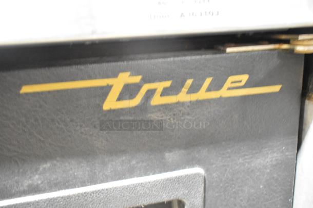 True TDB-24-48 kegerator, metal, 3 tap beer tower, 115 volts, 1 phase, True logo, commercial use, shown in close-up.