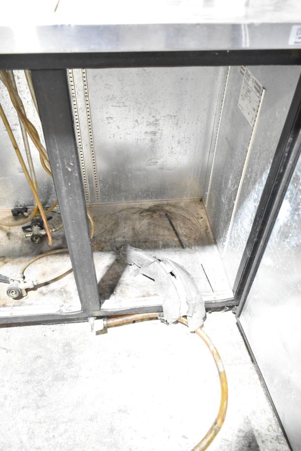 True TDB-24-48 metal commercial kegerator interior, features 3 tap beer tower. Visible tubing and wiring, 115 volts, 1 phase.