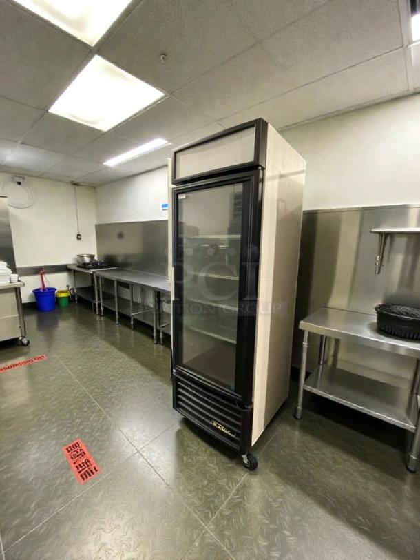 Alt text: True GDM-23 glass door merchandiser refrigerator, premium condition, 115V, single phase, fully tested, sleek black frame.