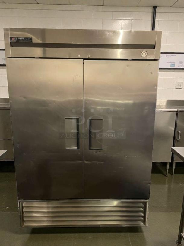 True T-49F commercial freezer, stainless steel, double doors, excellent condition, True Manufacturing, model label visible.