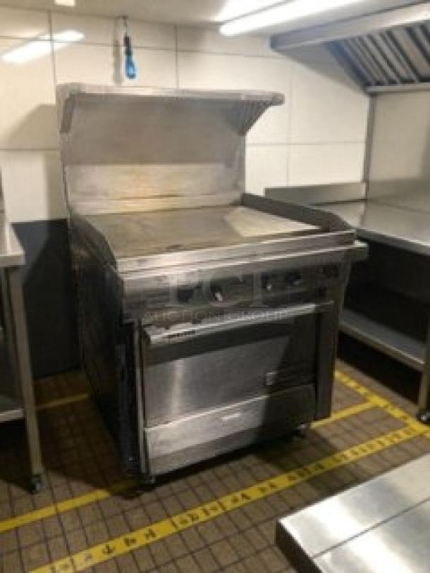 Like-new commercial gas range with flat griddle and oven by Commercial Kitchen Equipment USA. Fully tested and working.