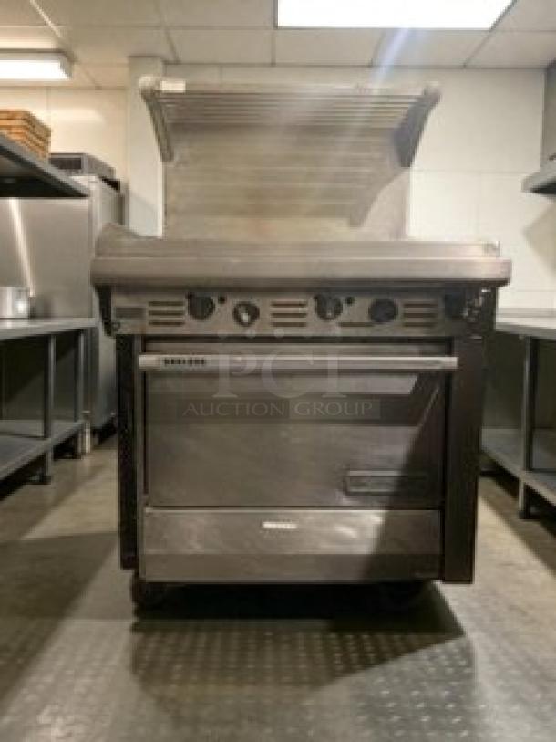 Commercial gas range with flat griddle and oven, like-new condition, model GAS-L-RNG-0183, fully tested and working.