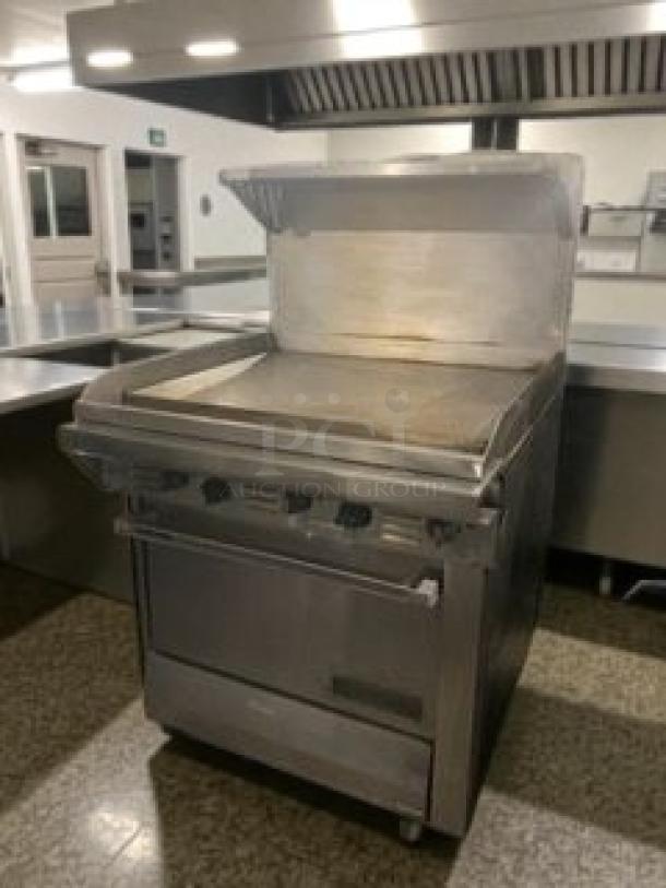 Like-new commercial gas range with flat griddle and oven by Commercial Kitchen Equipment, USA. Fully tested. Model GAS-L-RNG-0183.