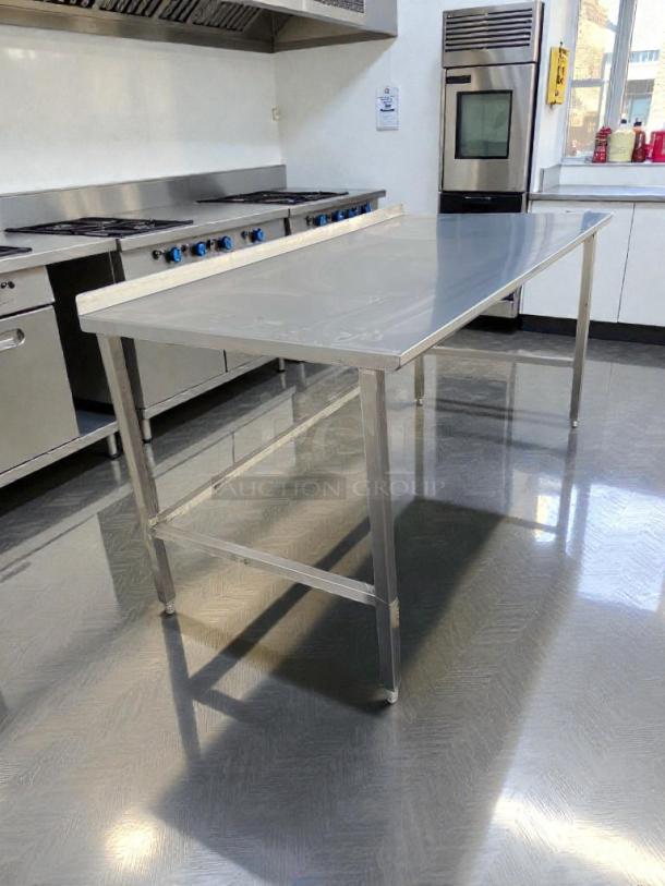 Commercial stainless steel work table, 72" with backsplash. High-grade condition, fully inspected, scratch-resistant surface.