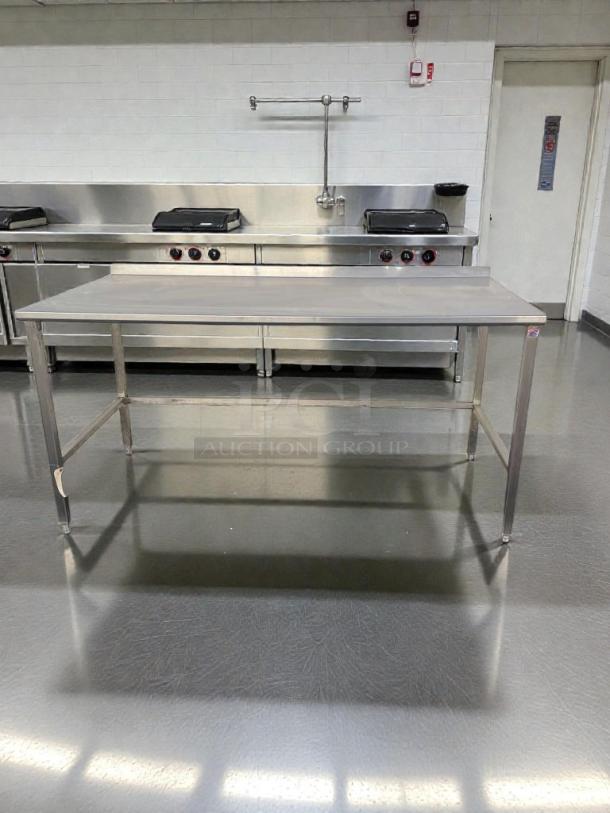 Stainless steel commercial work table, 72" model SS-S-TBL-0184, high-grade condition, with backsplash, inspected, ready for use.
