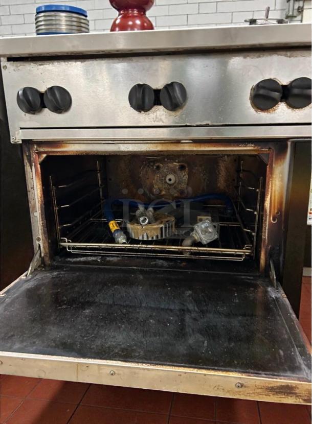 Vulcan 36C-6BN 36" commercial gas range with oven, natural gas, top-tier condition, featuring multiple control knobs and interior racks.