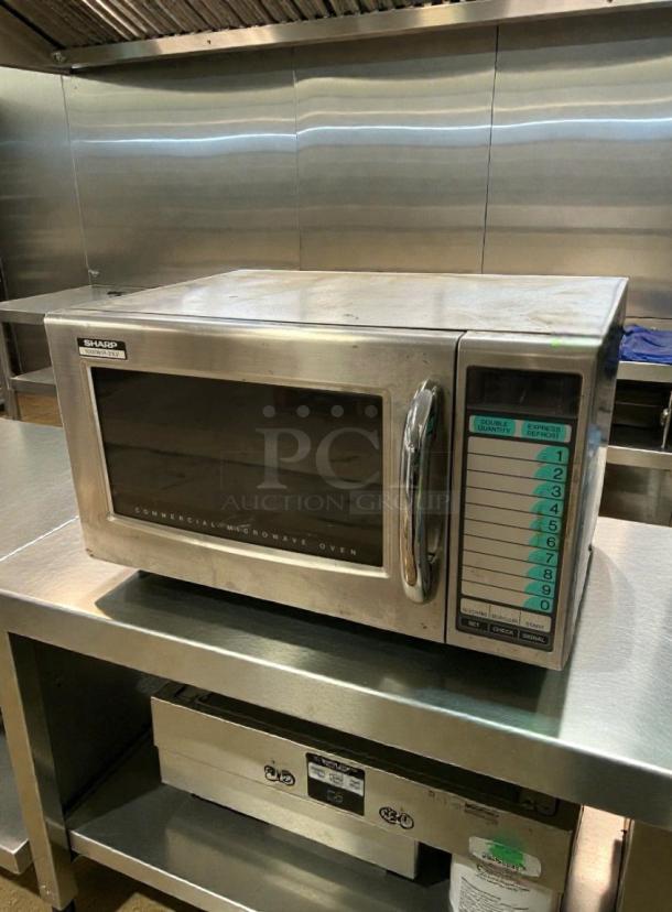 Sharp R-21LVF Commercial Microwave Oven, stainless steel, excellent condition, 120V, with control panel and label visible.