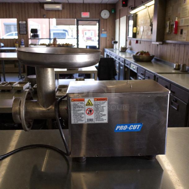 Pro-Cut KG-12FS commercial meat grinder, 115V, excellent condition, stainless steel, visible safety labels, fully tested.