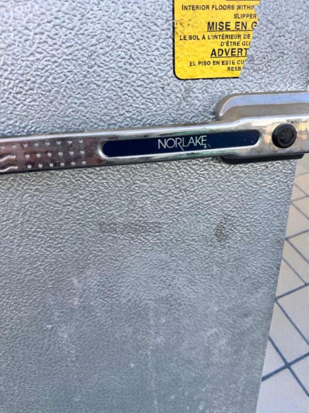 Nor-Lake walk-in cooler/freezer door in immaculate condition, featuring a visible Nor-Lake logo and caution label.