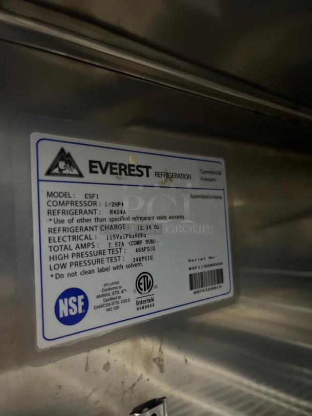 EVEREST ESF1 commercial freezer label showing model, refrigerant type, electrical specs, and NSF certification.