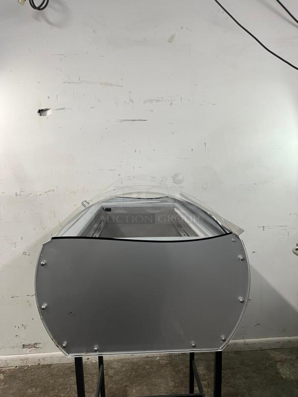 Tecfrigo Microgel 2 countertop ice cream display case in silver. Features curved glass, metal frame; appears in good condition.