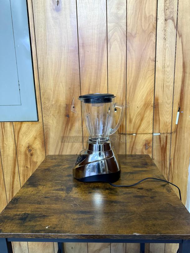 Oster Pro 500 Blender with glass jar and brushed nickel base. Used condition, complete with black lid.