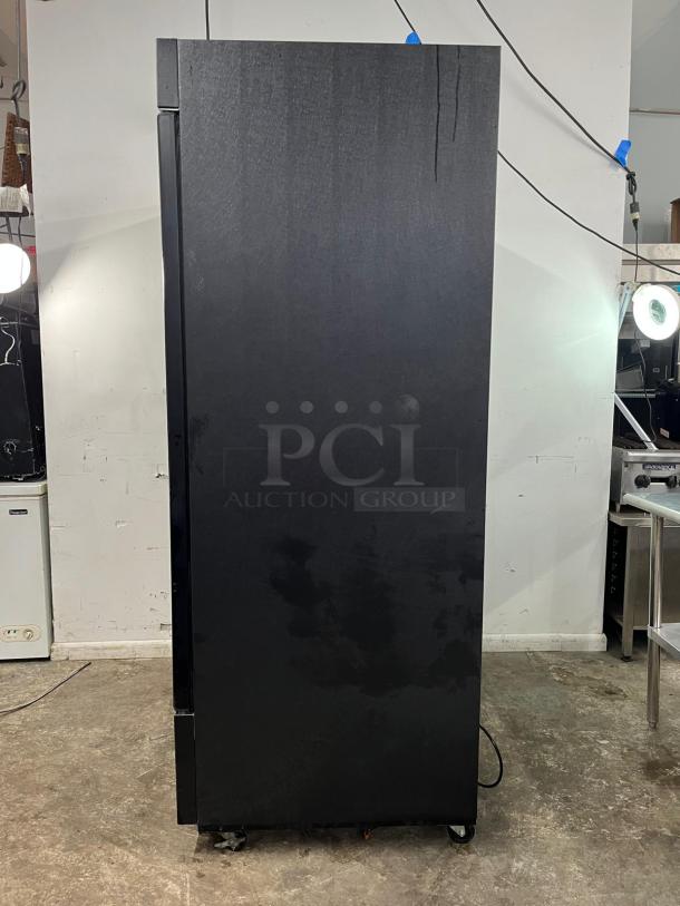 EDESA EDMO-49 double door commercial merchandiser, black exterior, on wheels, in good condition.