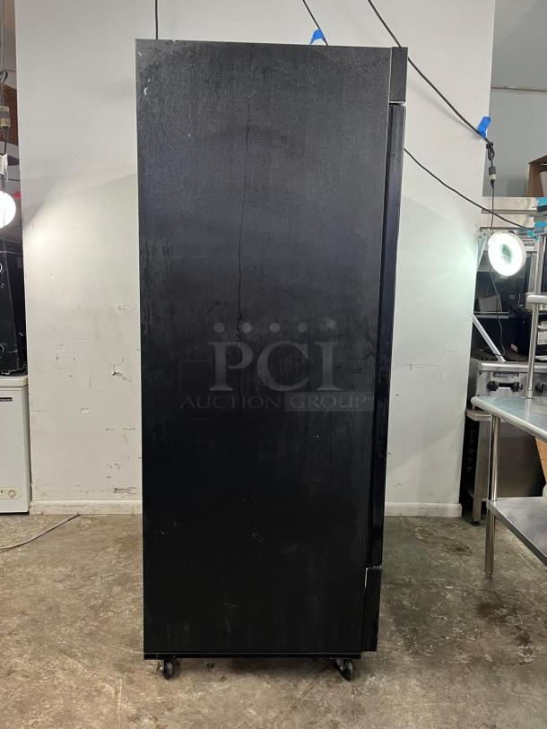 EDESA EDMO-49 double door commercial merchandiser, black exterior, on casters, visible wear, suitable for retail use.