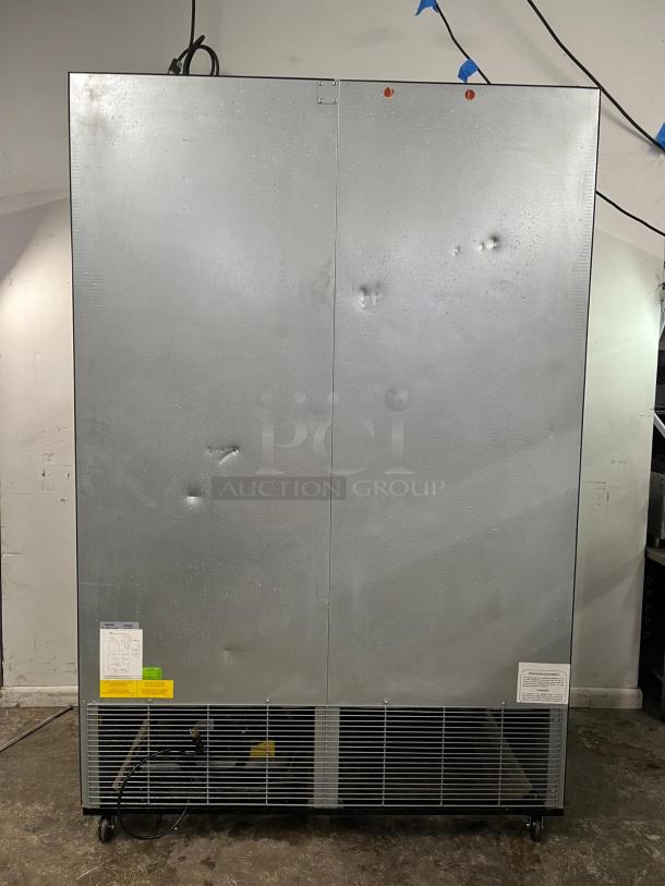 EDESA Double Door Commercial Merchandiser, Model EDMO-49, silver finish, visible dents, with labels and caster wheels.